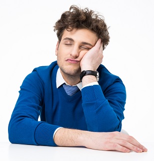 Tired businessman sleeping at the table over white background