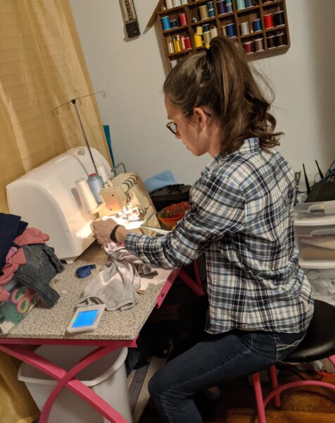 Tasha sitting at sewing machine